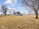 House nestled in a large, grassy yard with trees at 7279 W State Road 44, Shelbyville, IN 46176