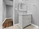 Clean bathroom with a white vanity and grey tile floor at 7279 W State Road 44, Shelbyville, IN 46176