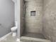 Modern bathroom with a large tiled shower and grey tile floor at 7279 W State Road 44, Shelbyville, IN 46176
