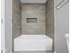 Modern bathroom with a large tiled shower and a white bathtub at 7279 W State Road 44, Shelbyville, IN 46176