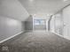 Bright bonus room with grey walls, carpet, and two windows at 7279 W State Road 44, Shelbyville, IN 46176