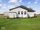 Side view of the house showing landscaping and outbuilding at 7279 W State Road 44, Shelbyville, IN 46176