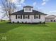 White house exterior with black shutters and a grassy lawn at 7279 W State Road 44, Shelbyville, IN 46176