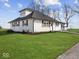 White farmhouse exterior with gray roof and a large lawn at 7279 W State Road 44, Shelbyville, IN 46176
