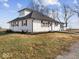 White house with black accents, landscaped yard, and driveway at 7279 W State Road 44, Shelbyville, IN 46176