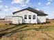 Side view of a white house with shed and landscaping at 7279 W State Road 44, Shelbyville, IN 46176