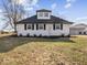 Front view of a charming white farmhouse at 7279 W State Road 44, Shelbyville, IN 46176