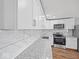 Modern kitchen with white cabinets and granite countertops at 7279 W State Road 44, Shelbyville, IN 46176