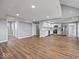Open kitchen with white cabinets, stainless steel appliances, and hardwood floors at 7279 W State Road 44, Shelbyville, IN 46176