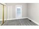 Neutral bedroom showcasing plush carpeting and a sunny window for natural light at 747 E Mccarty St, Indianapolis, IN 46203
