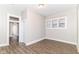 Bright room with wood-look floors and fresh paint, featuring a large window and trim at 747 E Mccarty St, Indianapolis, IN 46203
