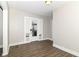 Bright living room with wood-look floors and fresh paint, featuring a glass door and trim at 747 E Mccarty St, Indianapolis, IN 46203