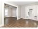 Bright living room with wood-look floors and fresh paint, featuring a large window at 747 E Mccarty St, Indianapolis, IN 46203