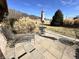 Backyard patio with seating and an outdoor umbrella overlooking the yard and trees at 1072 S State Road 67, Martinsville, IN 46151