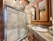 Bathroom featuring a glass door shower, vanity with decorative mirror, and neutral color palette at 1072 S State Road 67, Martinsville, IN 46151