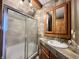 Well-maintained bathroom featuring a vanity with a sink, a frosted glass shower, and modern finishes at 1072 S State Road 67, Martinsville, IN 46151