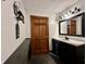 Bathroom featuring a black vanity and sink, decorative mirror, and neutral color palette at 1072 S State Road 67, Martinsville, IN 46151