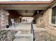 Spacious covered patio featuring brick accents, a ceiling fan, and ample room for outdoor furniture and activities at 1072 S State Road 67, Martinsville, IN 46151