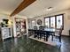 Dining room with a long black table, chairs, and a view of the front door at 1072 S State Road 67, Martinsville, IN 46151