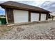 Spacious detached garage featuring three white doors and ample parking space at 1072 S State Road 67, Martinsville, IN 46151