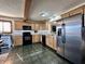 Eat-in kitchen featuring wood cabinetry, black appliances, and unique tile flooring at 1072 S State Road 67, Martinsville, IN 46151