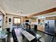 Spacious kitchen with a stainless steel refrigerator, wood cabinets, and a breakfast bar at 1072 S State Road 67, Martinsville, IN 46151