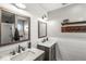 Bathroom with double sink vanity, shiplap wall, and modern fixtures at 12525 Wolford Dr, Fishers, IN 46038