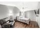 Spacious bedroom featuring vaulted ceiling, ceiling fan, and a comfortable recliner at 12525 Wolford Dr, Fishers, IN 46038