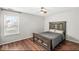 Bright bedroom with large window, ceiling fan, and hardwood floors at 12525 Wolford Dr, Fishers, IN 46038