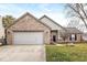 Charming brick and vinyl home with an attached two-car garage and well-maintained front yard at 12525 Wolford Dr, Fishers, IN 46038