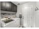 Well-equipped laundry room with gray cabinets and modern washer and dryer at 12525 Wolford Dr, Fishers, IN 46038