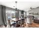 Combined dining and living area with hardwood floors, a fireplace, and sliding door access to the backyard at 12525 Wolford Dr, Fishers, IN 46038