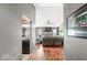 Open-concept living room with hardwood floors, a fireplace, and a view into the eat-in kitchen at 12525 Wolford Dr, Fishers, IN 46038