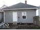 Rear view of a home with gray siding, a back entrance, and a small yard at 1258 W 29Th St, Indianapolis, IN 46208