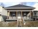 Charming single-story home with a cozy front porch and classic architectural details at 1258 W 29Th St, Indianapolis, IN 46208