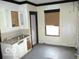 A kitchen featuring white cabinetry with a vintage sink and natural light at 1258 W 29Th St, Indianapolis, IN 46208