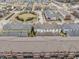 Aerial view of rooftops, lawns, and streetscape including pond in a well-planned community at 12755 Forsyth St, Carmel, IN 46032