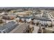 An aerial view displays various housing options near a beautiful pond and tennis courts at 12755 Forsyth St, Carmel, IN 46032