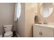 Bathroom featuring a toilet, sink, and a round window at 12755 Forsyth St, Carmel, IN 46032