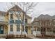 A welcoming yellow home with a covered front porch and beautiful blue accents at 12755 Forsyth St, Carmel, IN 46032