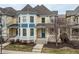 Attractive yellow townhouse with a quaint covered porch, surrounded by bare trees at 12755 Forsyth St, Carmel, IN 46032