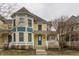 A two-story yellow home with a welcoming covered front porch and blue accents at 12755 Forsyth St, Carmel, IN 46032