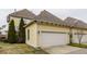 Attached two-car garage with white door and yellow siding, offering convenient parking and storage at 12755 Forsyth St, Carmel, IN 46032