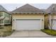 Attached two-car garage with white door and yellow siding, providing secure parking and storage at 12755 Forsyth St, Carmel, IN 46032
