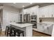 Modern kitchen island with a gas cooktop, stainless steel appliances, and white cabinetry at 12755 Forsyth St, Carmel, IN 46032