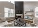 Bright living room featuring a fireplace, high ceilings, and large windows for ample natural light at 12755 Forsyth St, Carmel, IN 46032