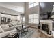 Spacious living room with high ceilings, fireplace, and an open view to the modern kitchen at 12755 Forsyth St, Carmel, IN 46032