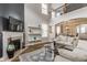 Open-concept living room with a fireplace, wood floors, and access to the dining area at 12755 Forsyth St, Carmel, IN 46032