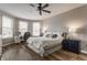 Stylish bedroom with a ceiling fan, hardwood floors, windows, and a desk area creates an inviting and functional space at 12755 Forsyth St, Carmel, IN 46032