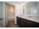 Bathroom with double vanity, modern faucets, and a view to the shower and toilet at 1407 Foxtail Ln, Greenwood, IN 46143